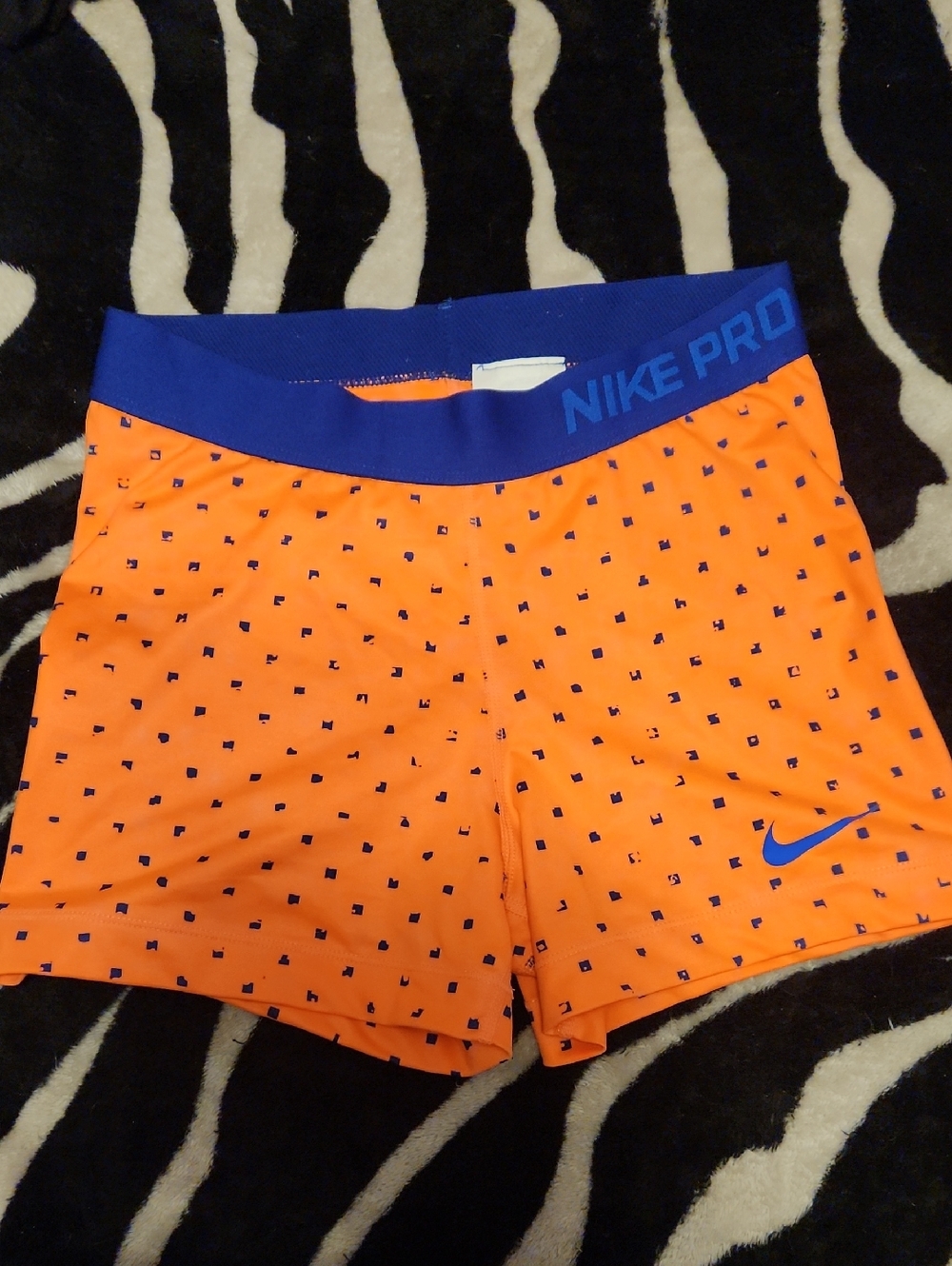 Nike Orange Athletic Shorts with Blue Waistband and Swoosh
